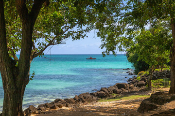 Exposure of the amazing la Cuvette Beach, located in the center of the busy town of Grand Bay, with crystal clear water and beautiful shades of blue perfect for who is looking for a relaxing vacation,