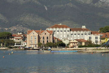 Typical view of the city of Budva, Montenegro from the sea, reflections of hotels  in the water. High quality photo