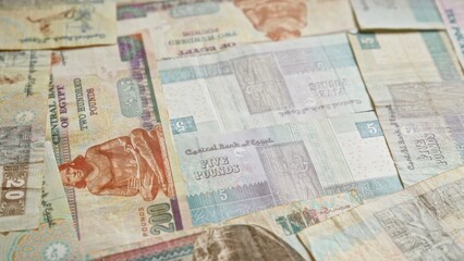 Egyptian five and two hundred pound banknotes laid out flat, showcasing colorful currency details from egypt.