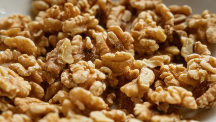 Closeup shot of shelled walnuts showing detailed texture of the nut meat.