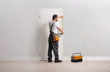 Carpenter measuring a door