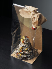 Chocolate dessert shaped like a Christmas tree. Gift. Christmas Celebration. 