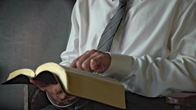 businessman open the book of the bible and read it indoors vintage retro style wall	

