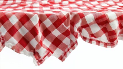 Obraz premium A red checkered picnic tablecloth neatly folded against a white background.