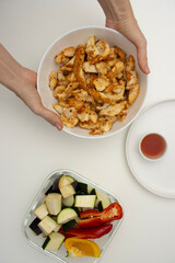 Piece of fried chicken skewered on a fork. Food close-up on white background, copy space