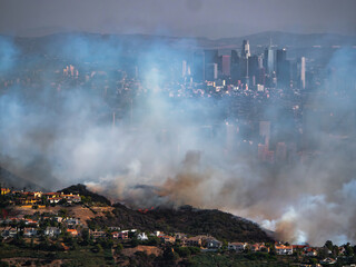 The Palisades Fire ravages homes in the Pacific Palisades with downtown LA in the background
