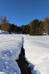 Small river making his way through the snow