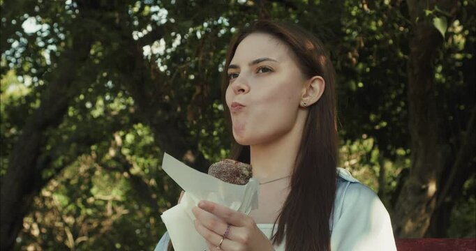 Young woman enjoying a sweet treat in nature