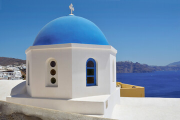 Oia village on Santorini island, Cyclades islands Aegean sea, Greece. Traditional white church with...