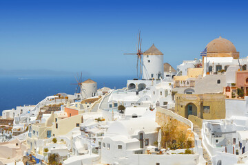 Oia village on Santorini island, Greece. Traditional and famous houses and windmill over the...