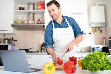One man is watching a cooking tutorial on internet