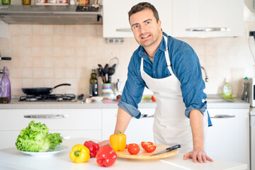 Man in the kitchen at home looking at the camera portrait