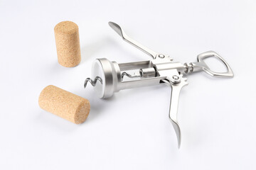 Wing corkscrew and corks on white background