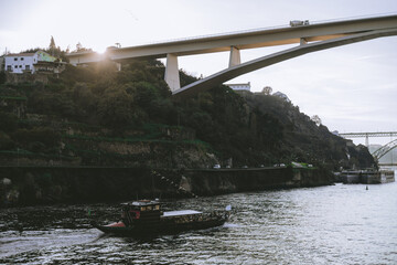 A scenic view of the Ponte do Infante bridge in Porto, Portugal, captured at sunset with a...