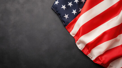 Obraz premium United States Flag Draped Elegantly Over a Dark Surface, Showcasing Its Vibrant Colors and Iconic Stars and Stripes During a Moment of Patriotism