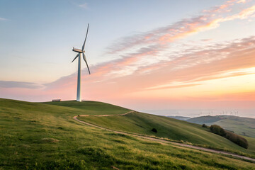Fototapeta premium Wind Turbine on a Gentle Hill at Sunrise