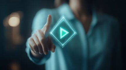 A woman is pointing at a video play button. The button is green and is located in the center of the image