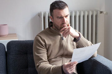 One man worried about bills reading energy increase costs