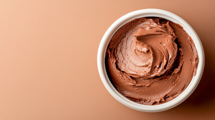 Creamy chocolate spread in a bowl on a neutral background for dessert lovers and baking enthusiasts