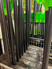 Obraz premium A collection of pens, each with green tops, is currently resting on a rack, ready for use or to be organized for better accessibility and display. They are possibly various types