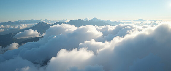 Fototapeta premium Pillow of Clouds above majestic mountain peaks under a clear blue sky conveying tranquility and serene beauty