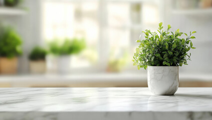 Fototapeta premium Blurred white kitchen interior with a marble countertop and a potted green plant in front of a blurred background, a panoramic banner for product display.