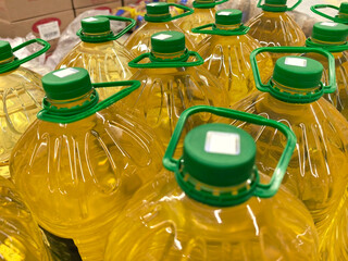 Brightly colored cooking oil bottles stacked in a vibrant market display