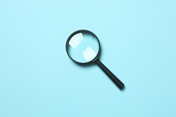 Magnifying glass on color background 