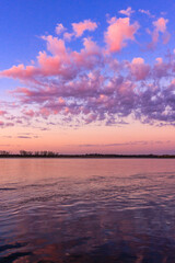 The sky is pink and the clouds are white