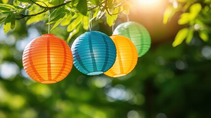 Fototapeta premium A group of colorful paper lanterns hanging from a tree branch