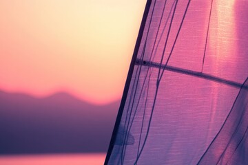 Sailboat sail illuminated by the sunset's warm glow, creating a serene and picturesque scene.