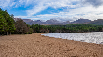 Sandy beach by a calm lake in Scotland, UK, captured on 2024-11-02.
