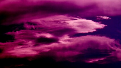Cloudy sky background with clouds in dark pink color - abstract natural patterns of clouds. Topics: abstraction, air space, meteorology, atmosphere, wallpaper