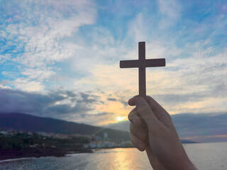 Christian prayer. Man on his knees praying on sunset background. Kneeling prayer to God.