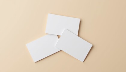  Close-up of a group of business card mockups, overlapping slightly, isolated on a neutral beige background