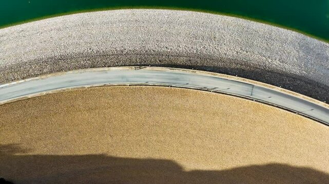 Curved Road Along Sandy Shoreline