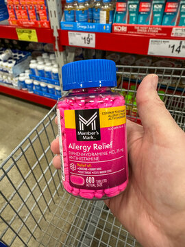 Bottle of Member's Mark Allergy Relief medication being held above a shopping cart. Merrillville, IN USA January 9, 2025
