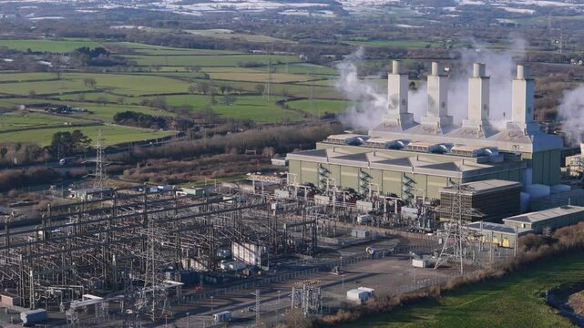 Aerial view of large power station and substation in the United Kingdom. Electricity grid concept