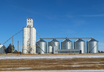 Agricultural grain elevator and storage bins on Colorado farm. © Tammy Yeokum
