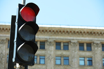 View of traffic light in city on sunny day, space for text