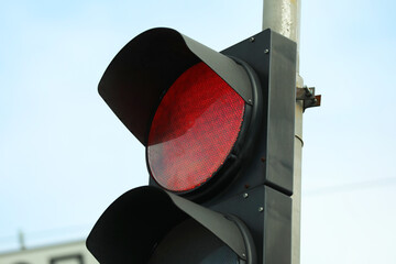 Traffic light against blue sky in city, closeup