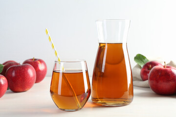 Fresh apple juice and fruits on white wooden table
