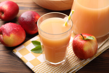 Tasty apple juice and fresh fruits on wooden table, closeup