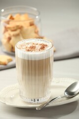Tasty latte macchiato in glass on white table, closeup. Coffee drink