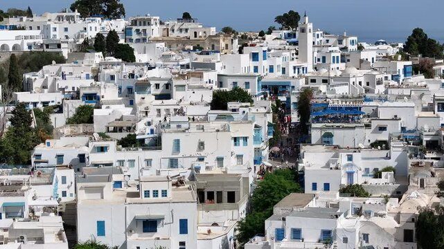 Aerial footage offering a sweeping view of the historic streets of Sidi Bou Said in Tunisia, known for its iconic blue accents, white facades, and spectacular Mediterranean atmosphere.
