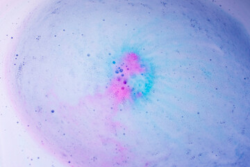 Pastel foam bubbles created by bath bomb dissolving in water