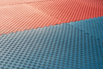 Red and blue karate dojo. Foam puzzle mat for martial arts exercises