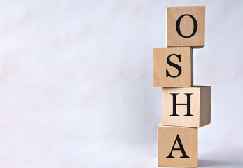 OSHA - acronym on wooden cubes on a white background