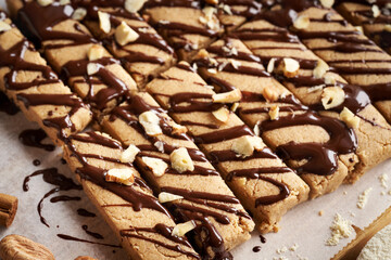 Homemade chocolate bars made of whey protein powder, ground oat flakes, maple syrup, cinnamon and nut butter