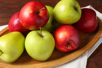 Fresh red and green apples on wooden table, closeup